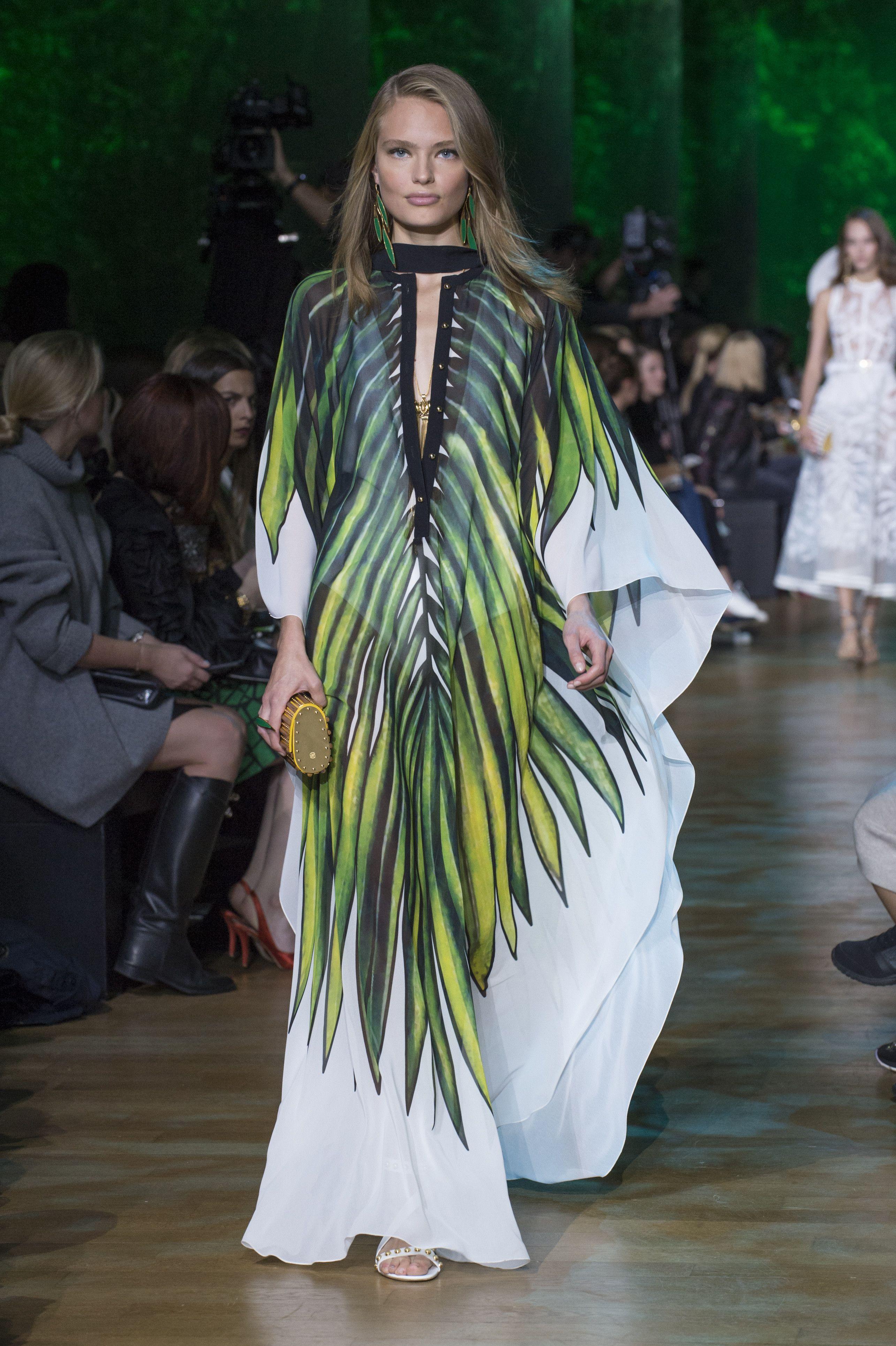Model wearing eco-friendly green leaf print kaftan dress on runway, Claire Powell style