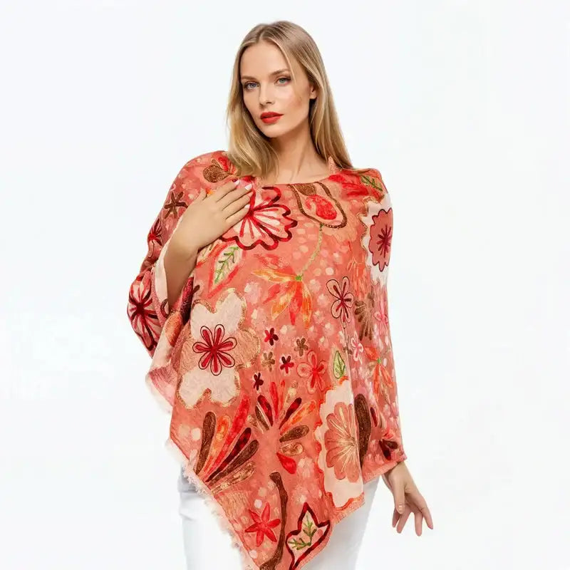 Woman wearing a floral print wool scarf from Claire Powell, styled over white outfit on white background.