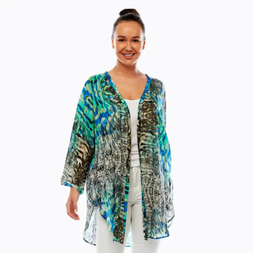 Woman wearing blue green patterned kimono jacket by Claire Powell, white background