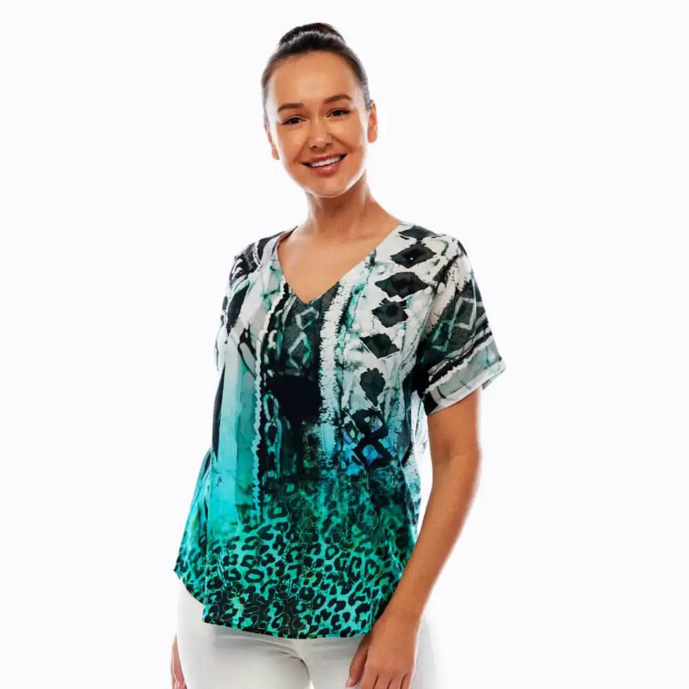Woman wearing Claire Powell V-neck short sleeve top with teal animal print, soft modal fabric