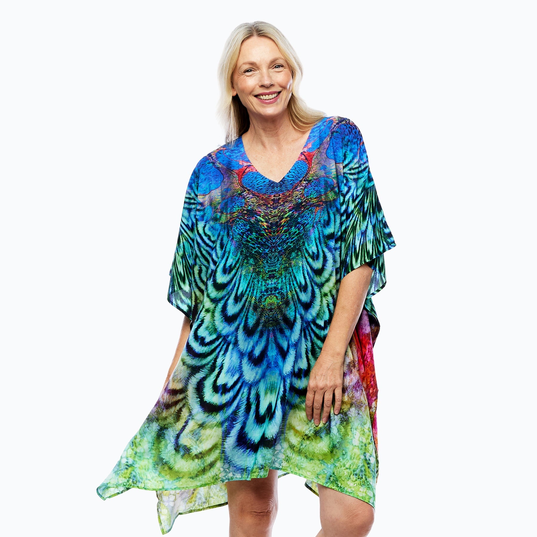 Woman wearing vibrant peacock print kaftan by Claire Powell, eco-friendly women's fashion
