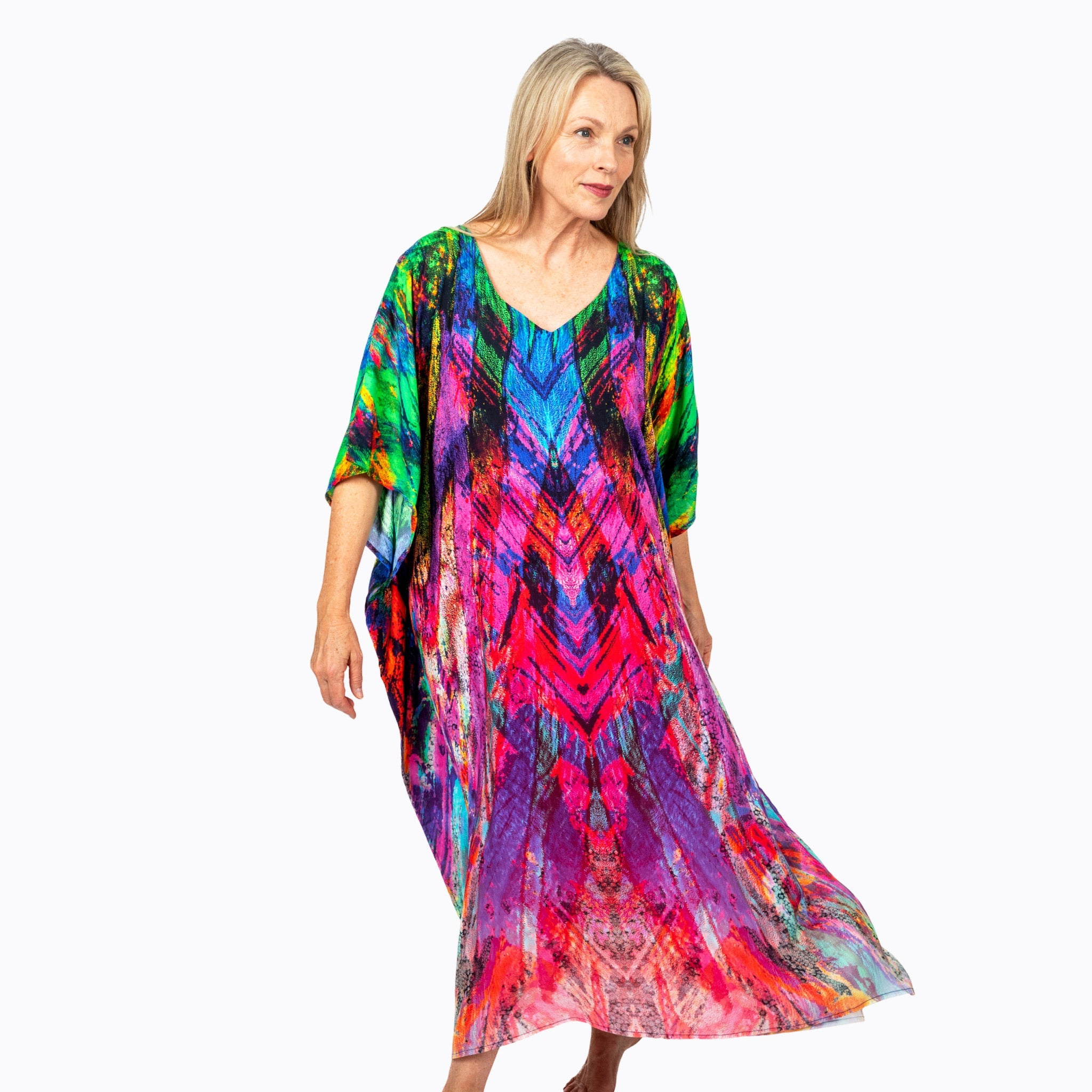 Woman wearing a vibrant multicolored kaftan dress from Claire Powell on white background