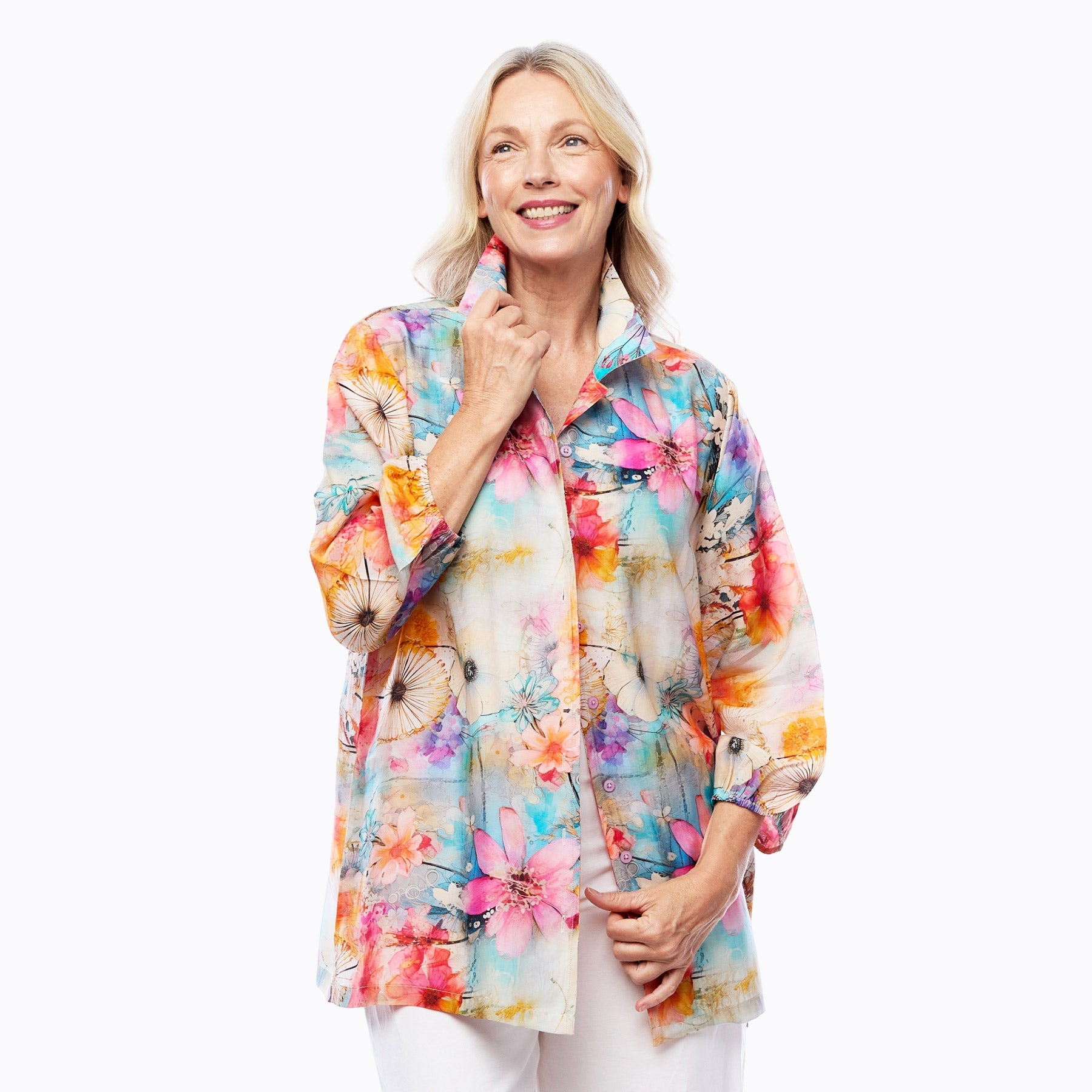 Woman wearing Claire Powell colorful floral button-up shirt with butterfly print