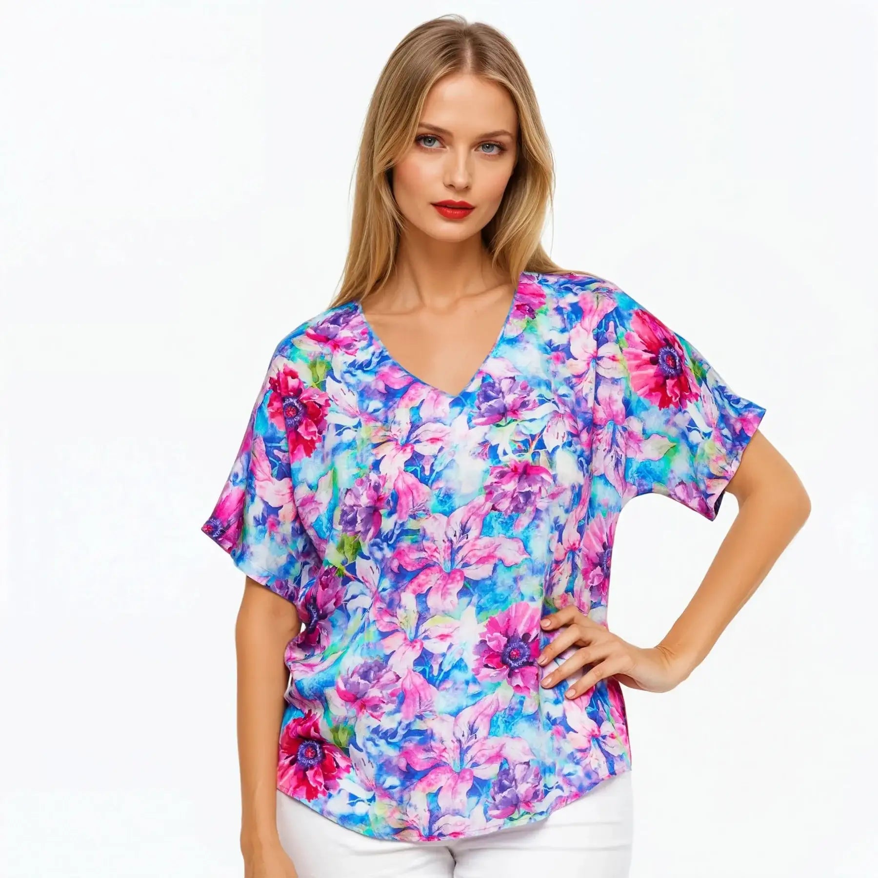 Woman wearing a vibrant floral print Claire Powell t-shirt, eco-friendly and stylish.