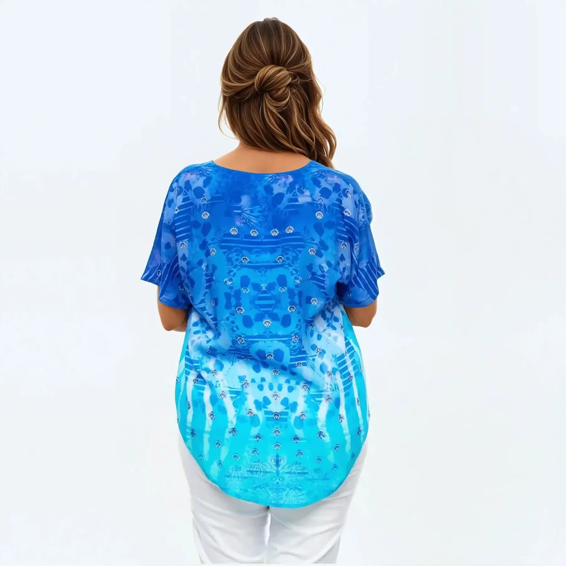 Woman wearing a blue patterned V-neck t-shirt by Claire Powell, seen from the back.