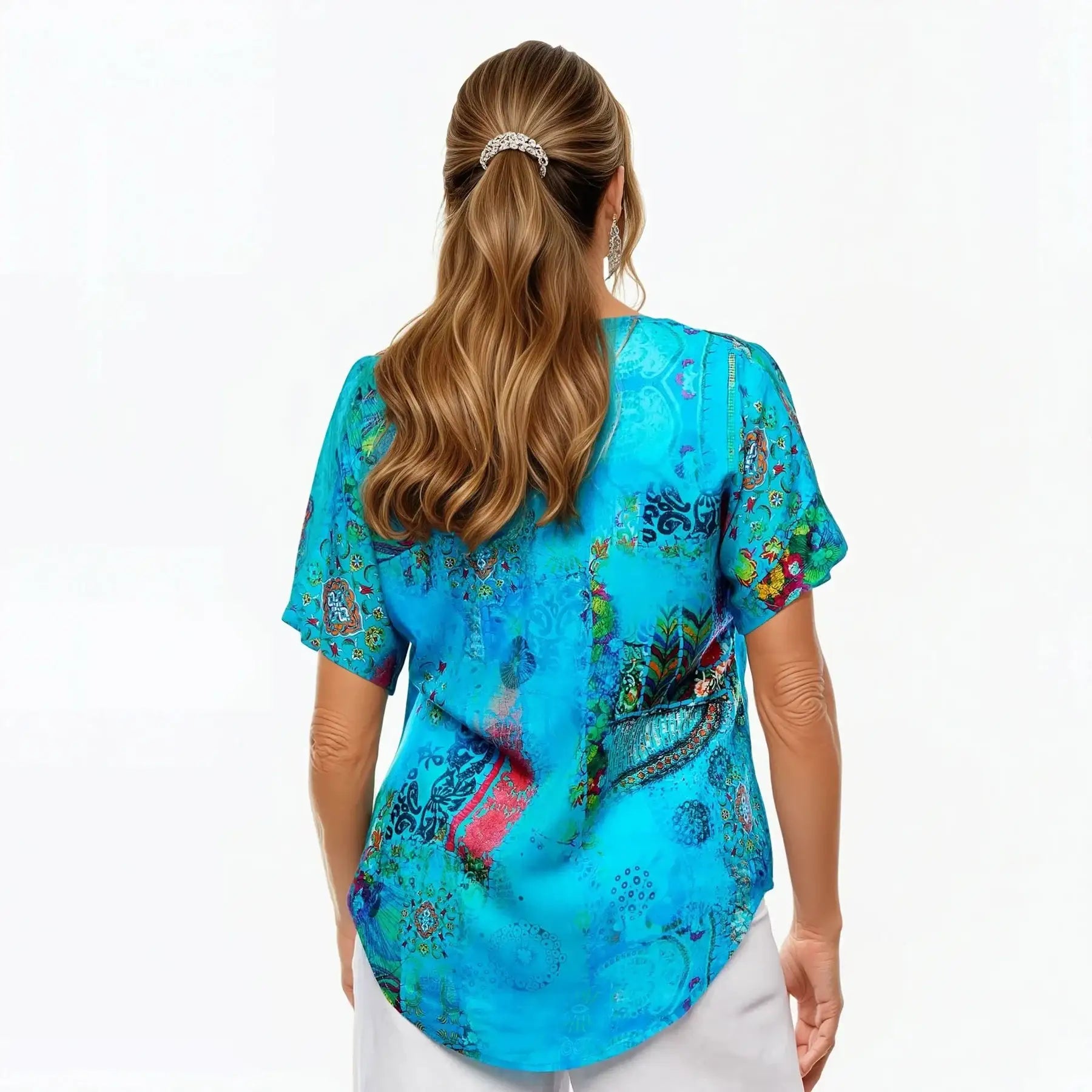 Woman wearing Claire Powell blue V-neck short sleeve printed tee, back view