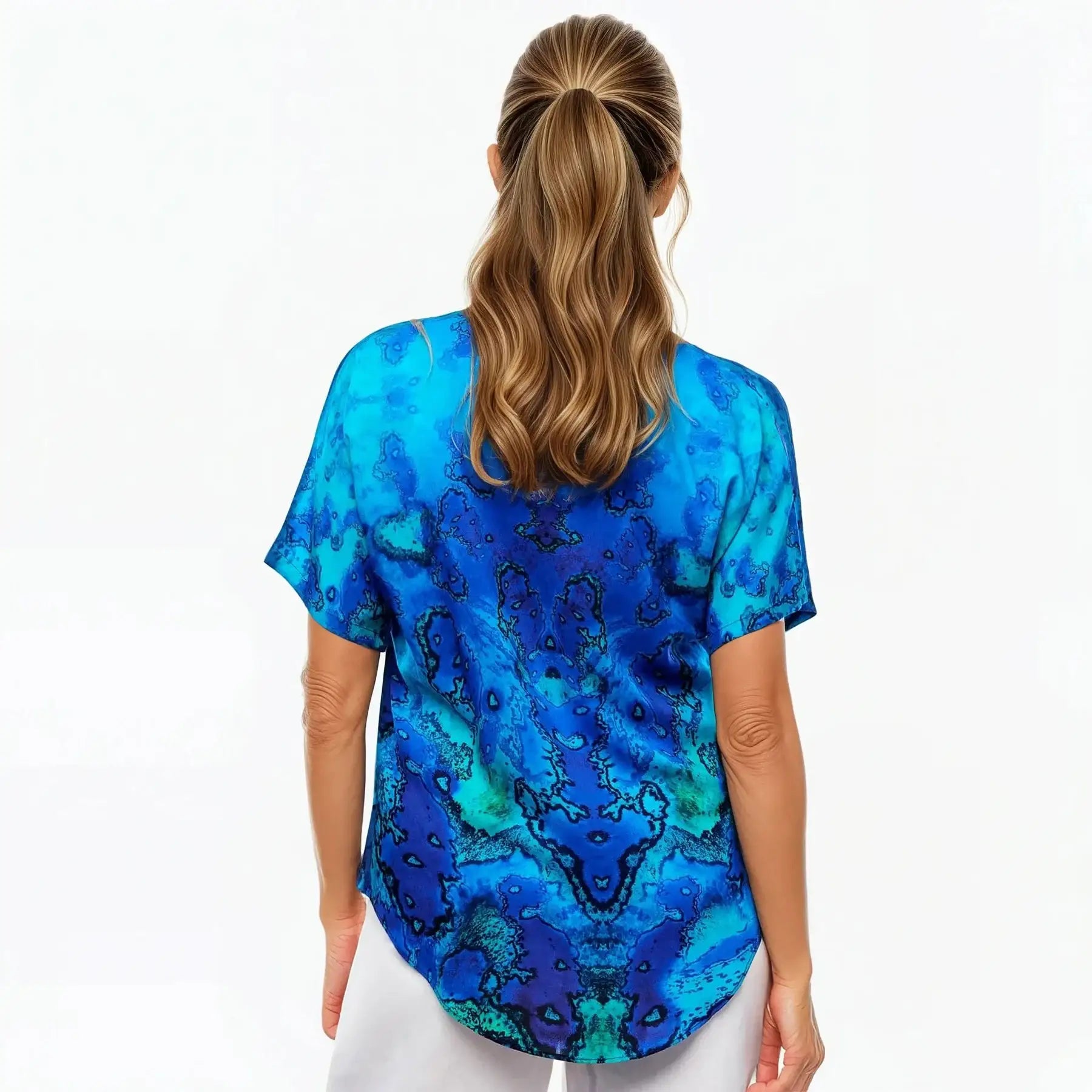 Back view of woman wearing blue V-neck reef print t-shirt from Claire Powell