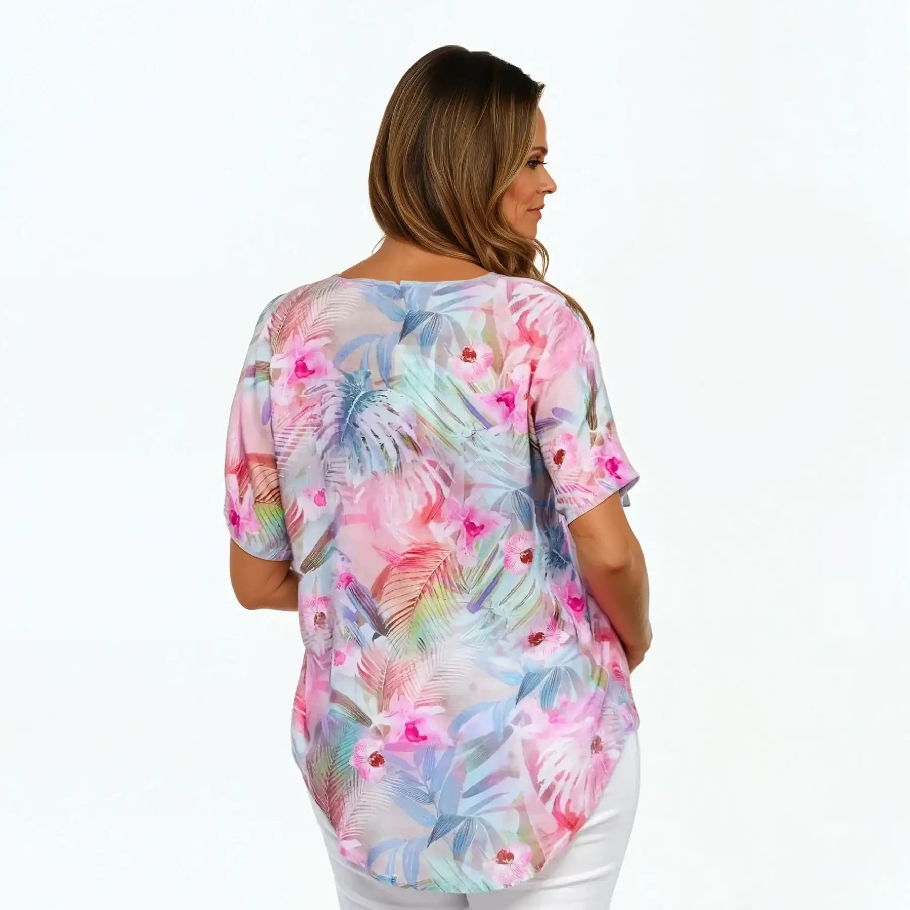 Woman wearing a colorful floral V-neck t-shirt by Claire Powell, back view, against white background.