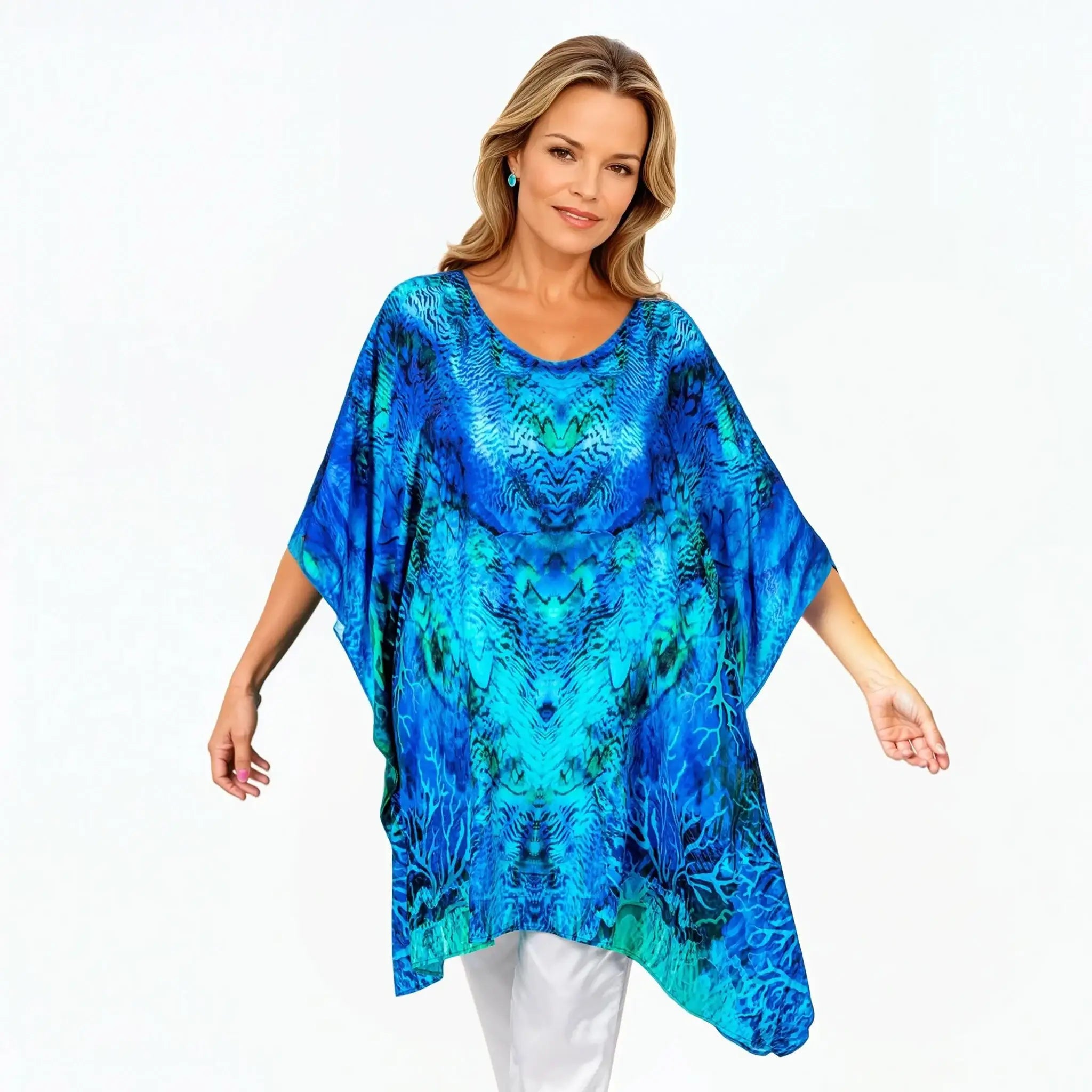 Woman wearing a vibrant blue kaftan top from Claire Powell, eco-friendly stylish women's clothing.