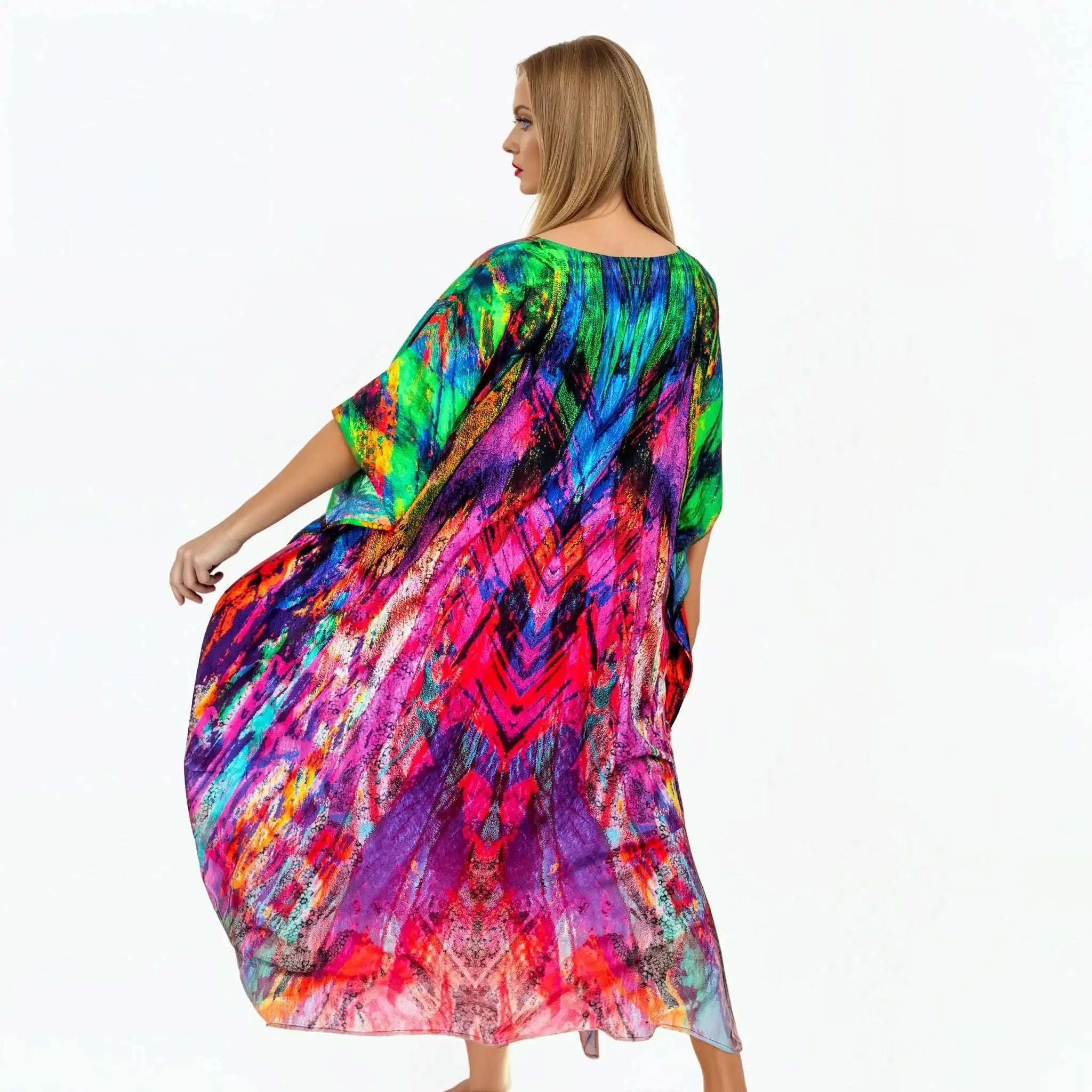 Woman wearing vibrant multicolor carnival kaftan by Claire Powell, back view