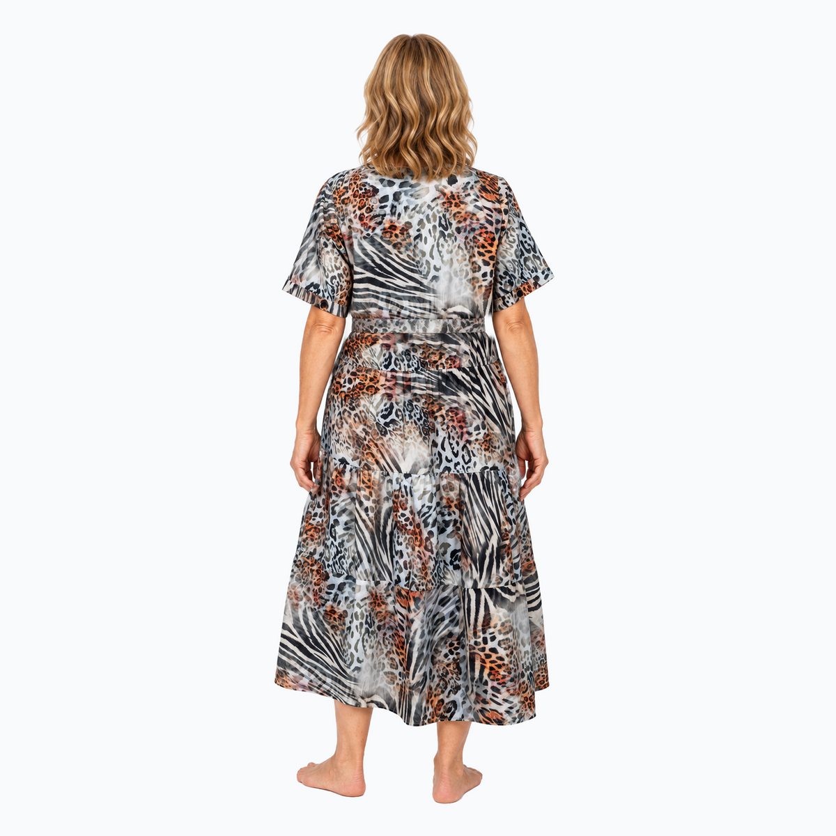 Model D wearing the Claire Powell Tiered A-line Midi Dress in Jungle with matching-fabric tie belt, back view