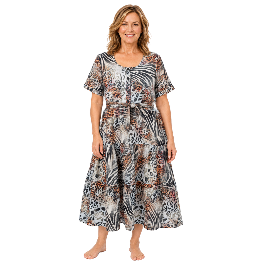 Woman wearing the Claire Powell Tiered A-line Midi Dress in Jungle with matching-fabric tie belt, front view