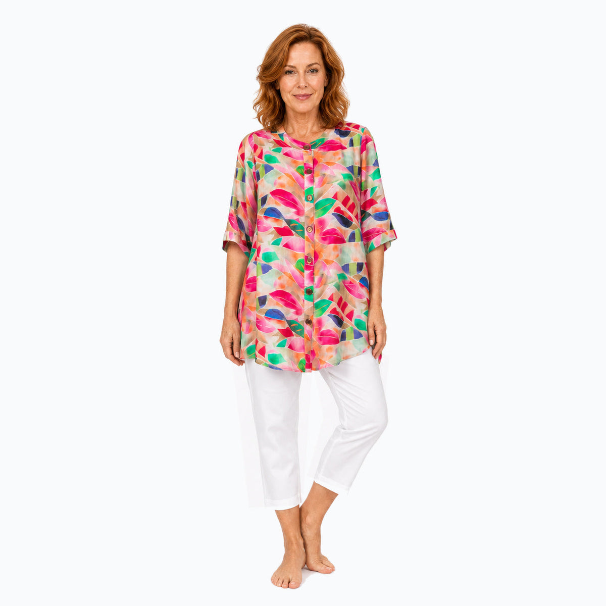 Woman wearing the Claire Powell La Peach A-Line Tunic Shirt with white capri pants, full-body three-quarter view