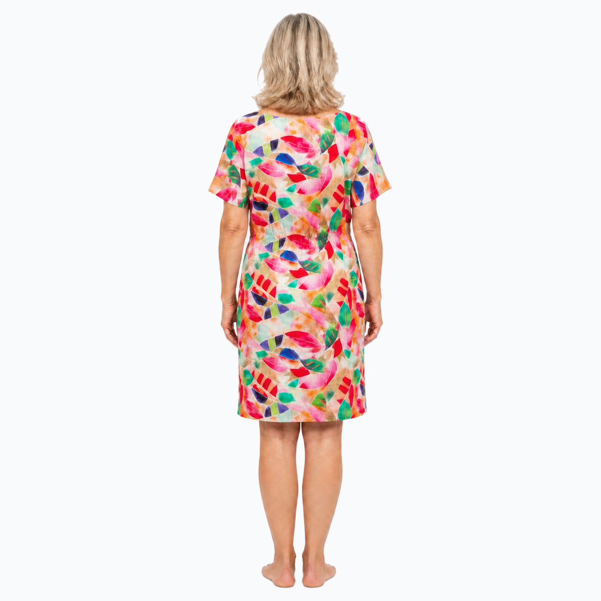 Woman wearing the Claire Powell La Peach Shift Dress, back view