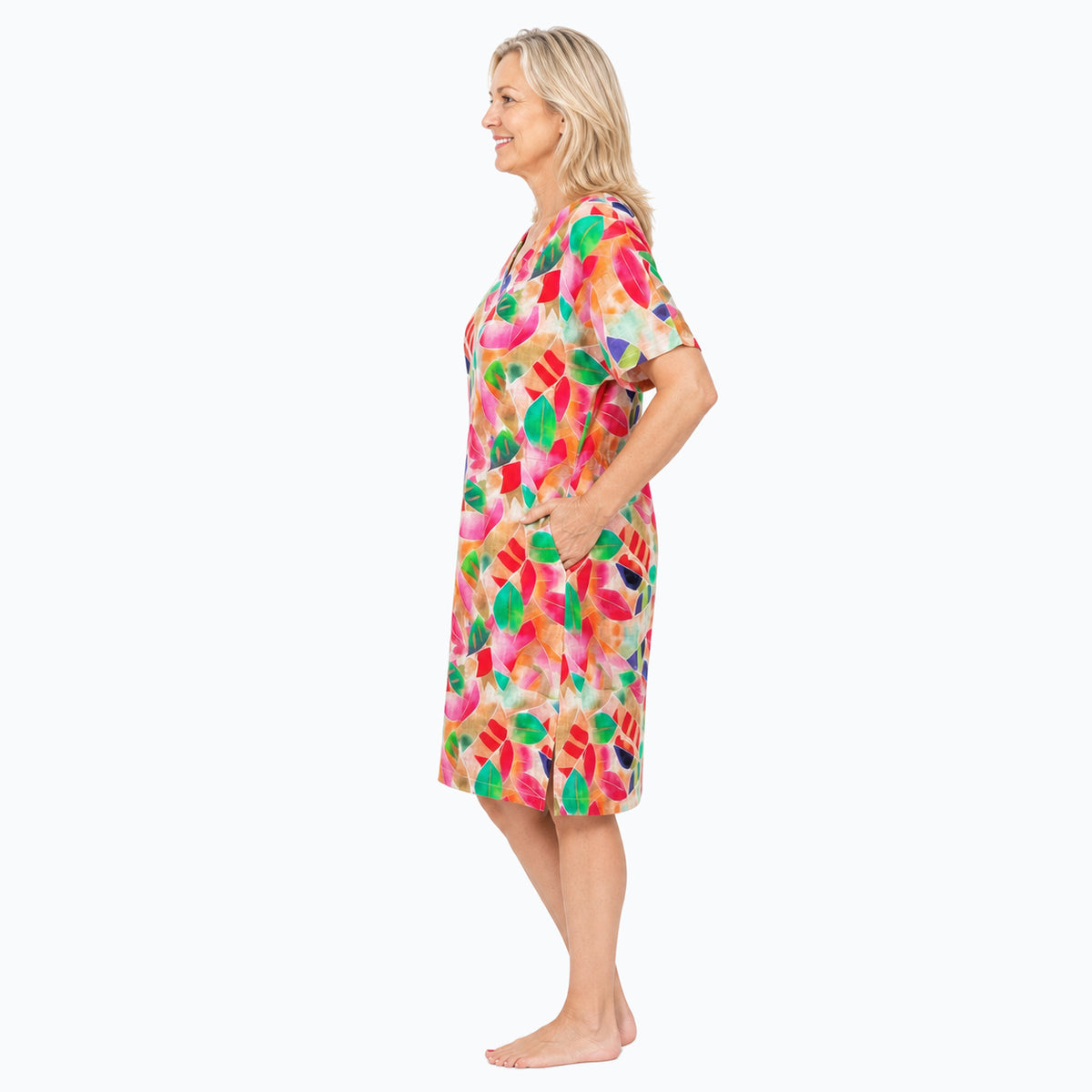 Woman wearing the Claire Powell La Peach Shift Dress, side view