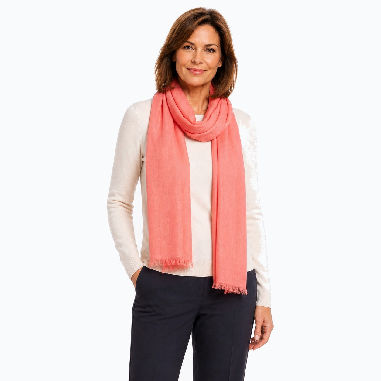 Woman wearing the Claire Powell Peach Silk Wool Scarf, three-quarter view