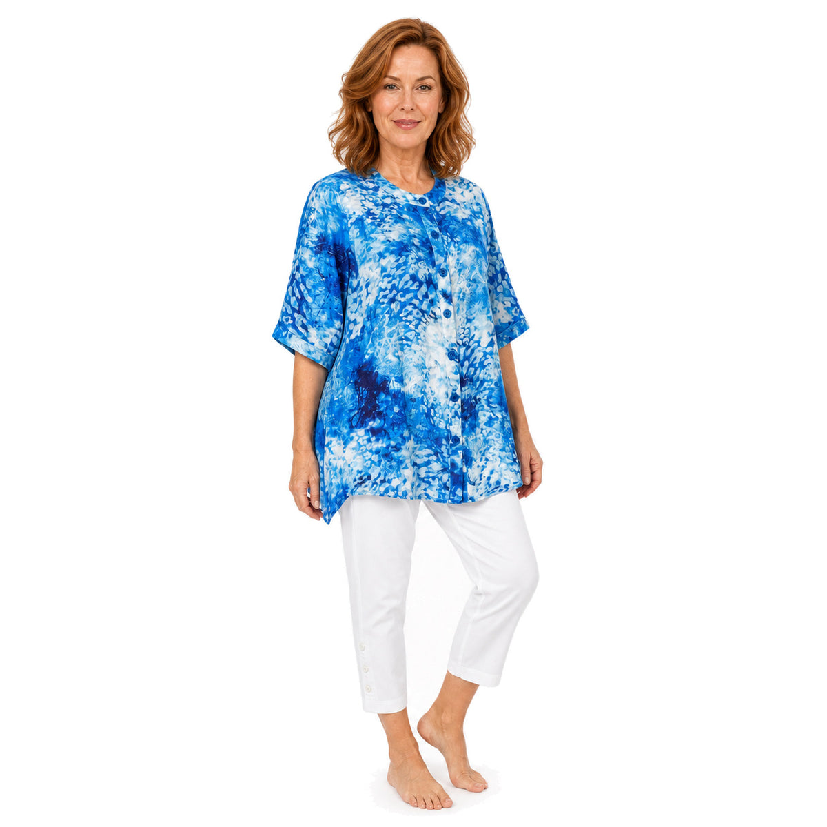 Woman wearing the Claire Powell Snowcat A-Line Tunic Shirt with white capris, barefoot three-quarter full-body view