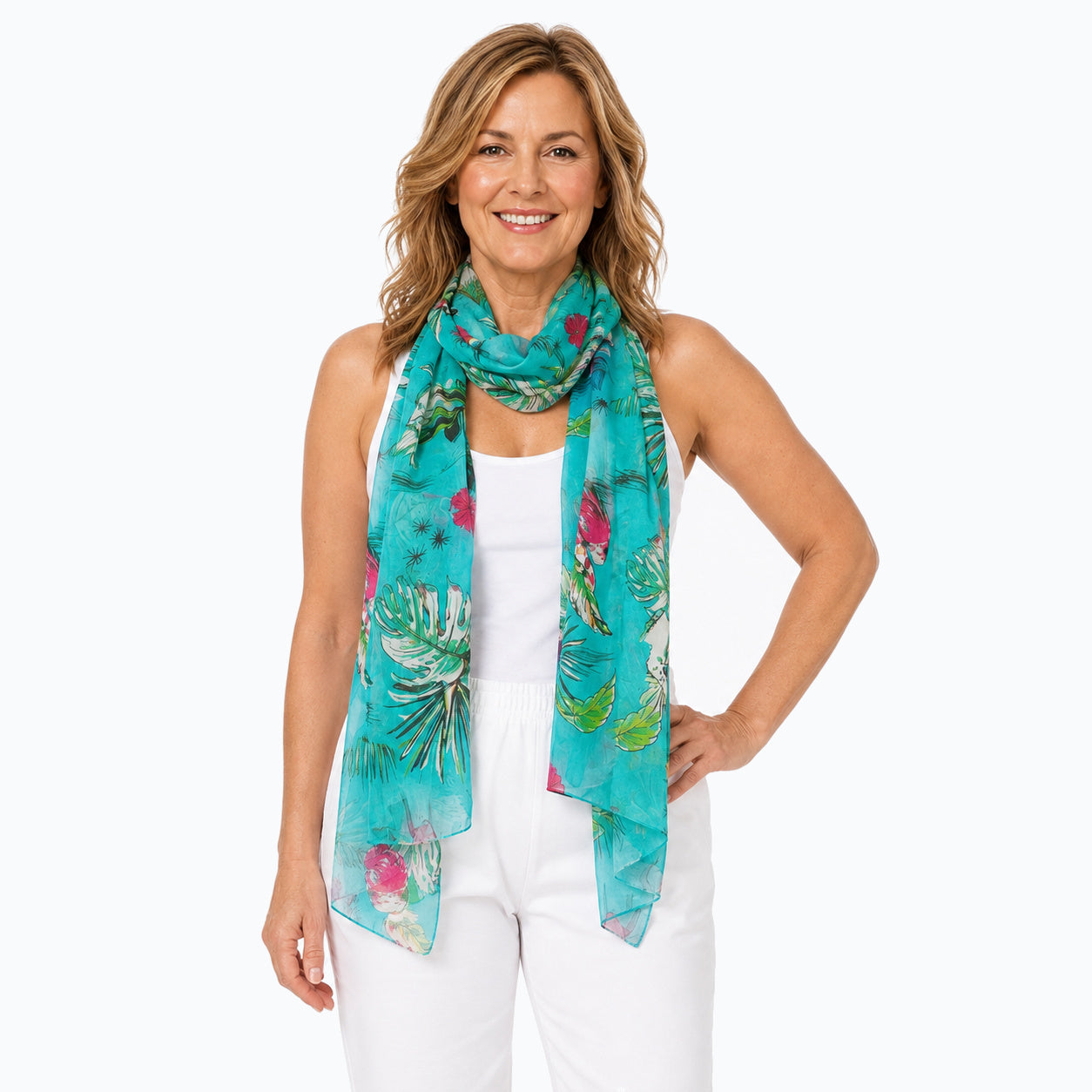 Woman wearing the Claire Powell Tweet silk scarf, looped around the neck with long hanging ends, white camisole and white capris