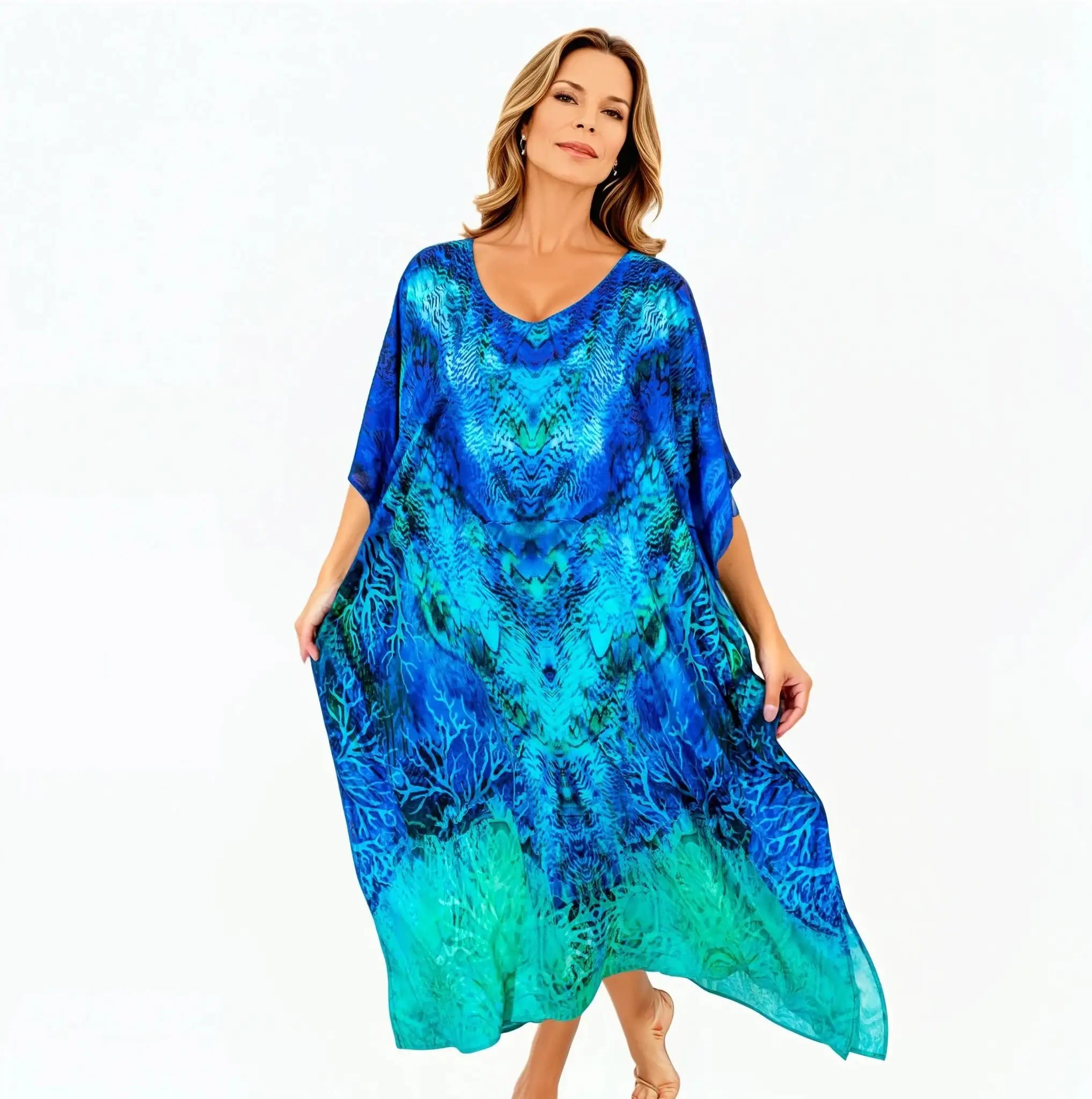Woman wearing a vibrant blue aquatica kaftan dress by Claire Powell on white background