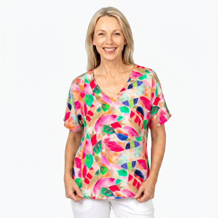 Woman wearing Claire Powell V-Neck T-Shirt in La Peach print, front view, white studio background