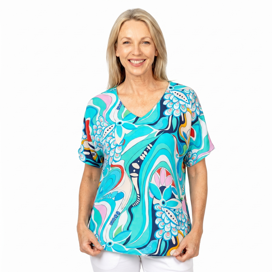 Woman wearing Claire Powell V-Neck T-Shirt in Sakura print, front view, white studio background