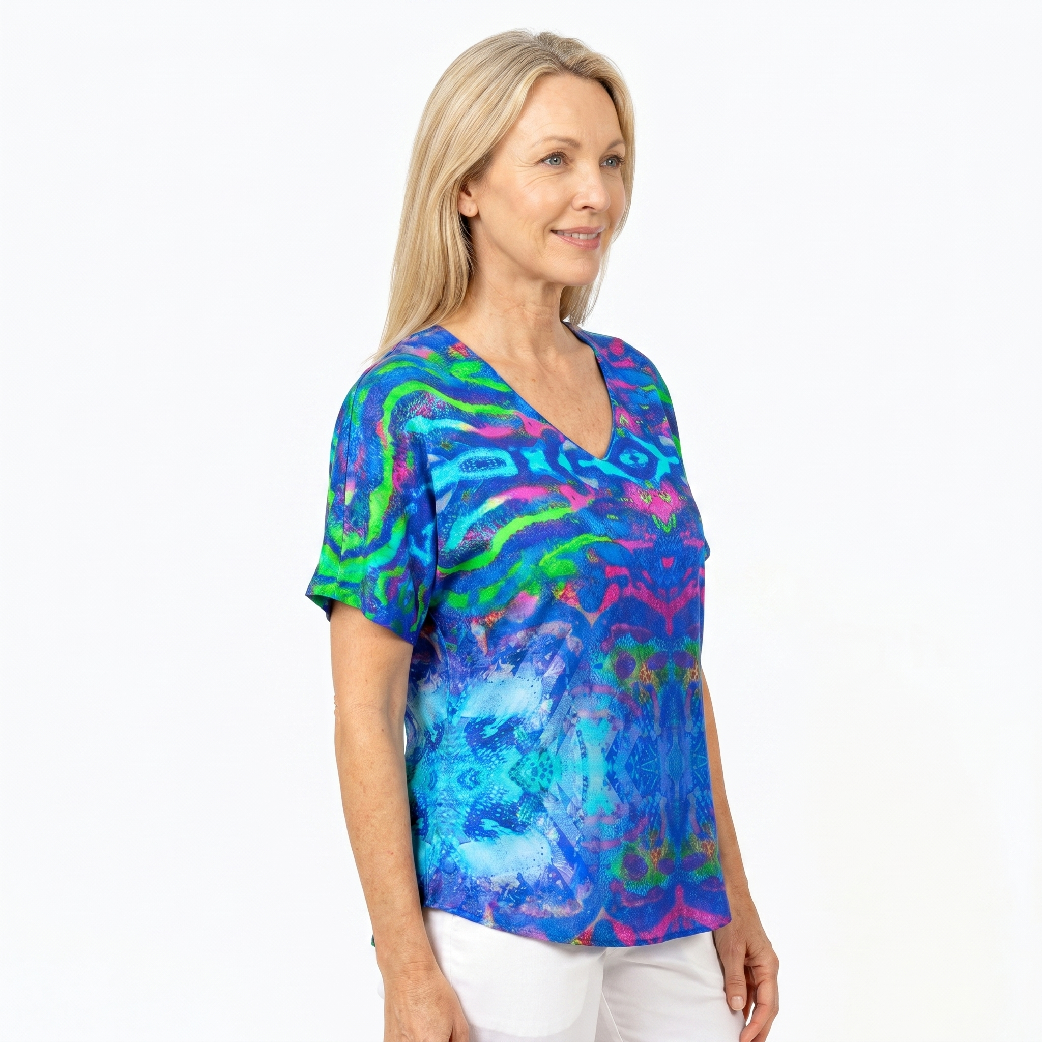 Woman wearing Claire Powell V-Neck T-Shirt in Mirage print, side view, white studio background