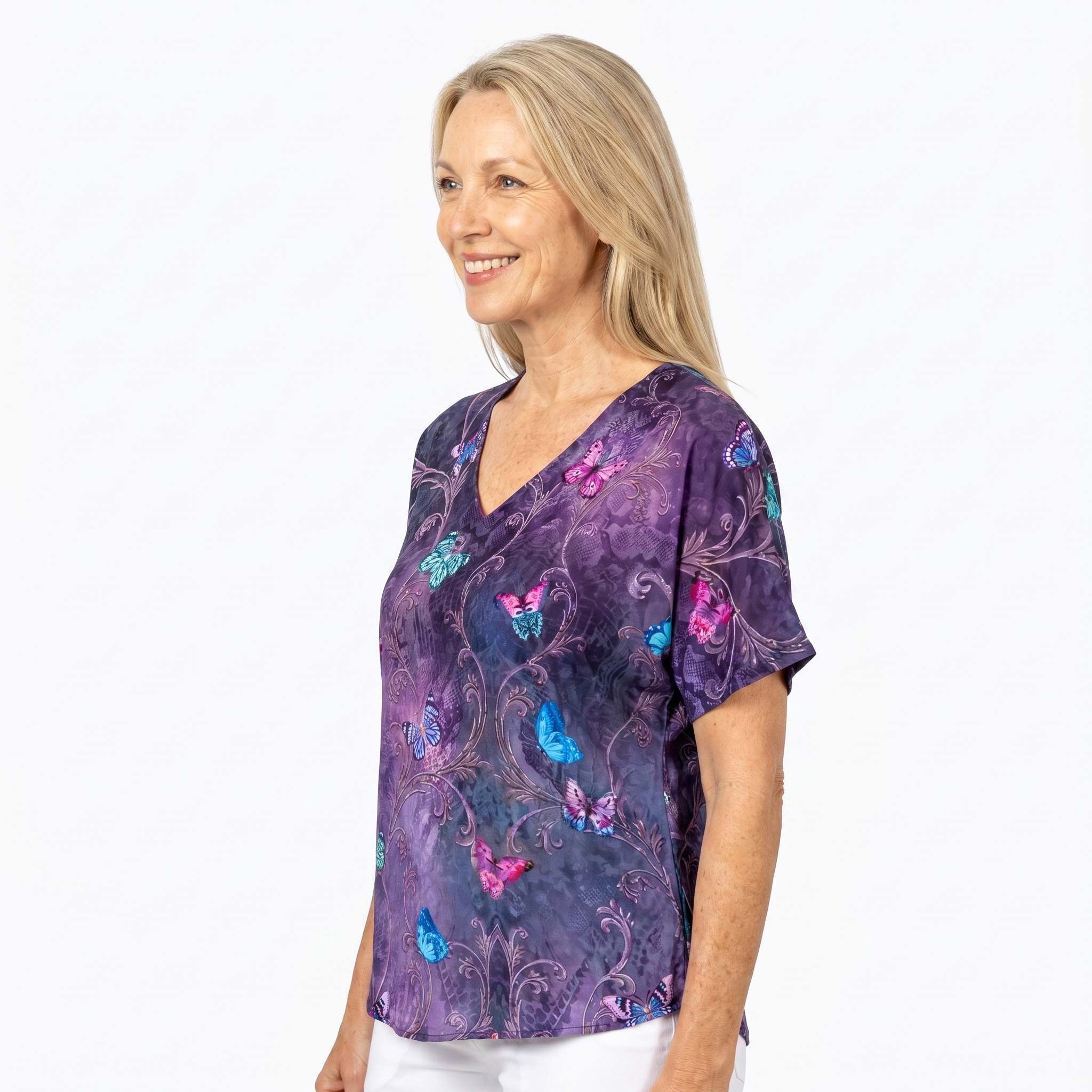Woman wearing Claire Powell V-Neck T-Shirt in Enchanted print, side view, white studio background