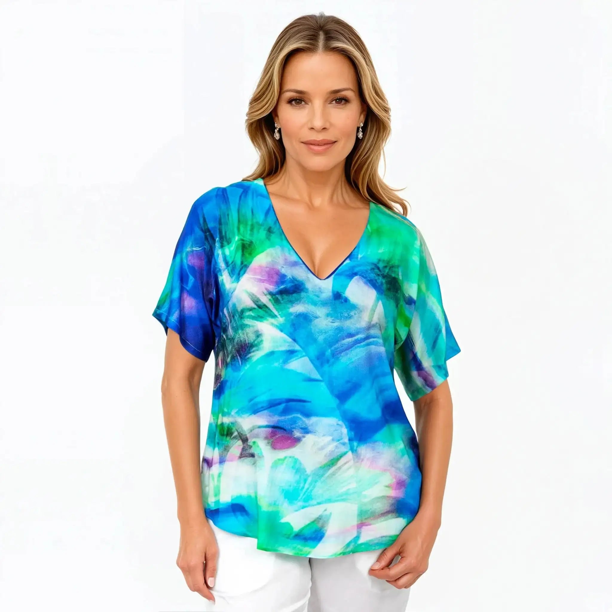 Woman wearing a blue green abstract print Claire Powell top, showcasing eco-friendly fashion