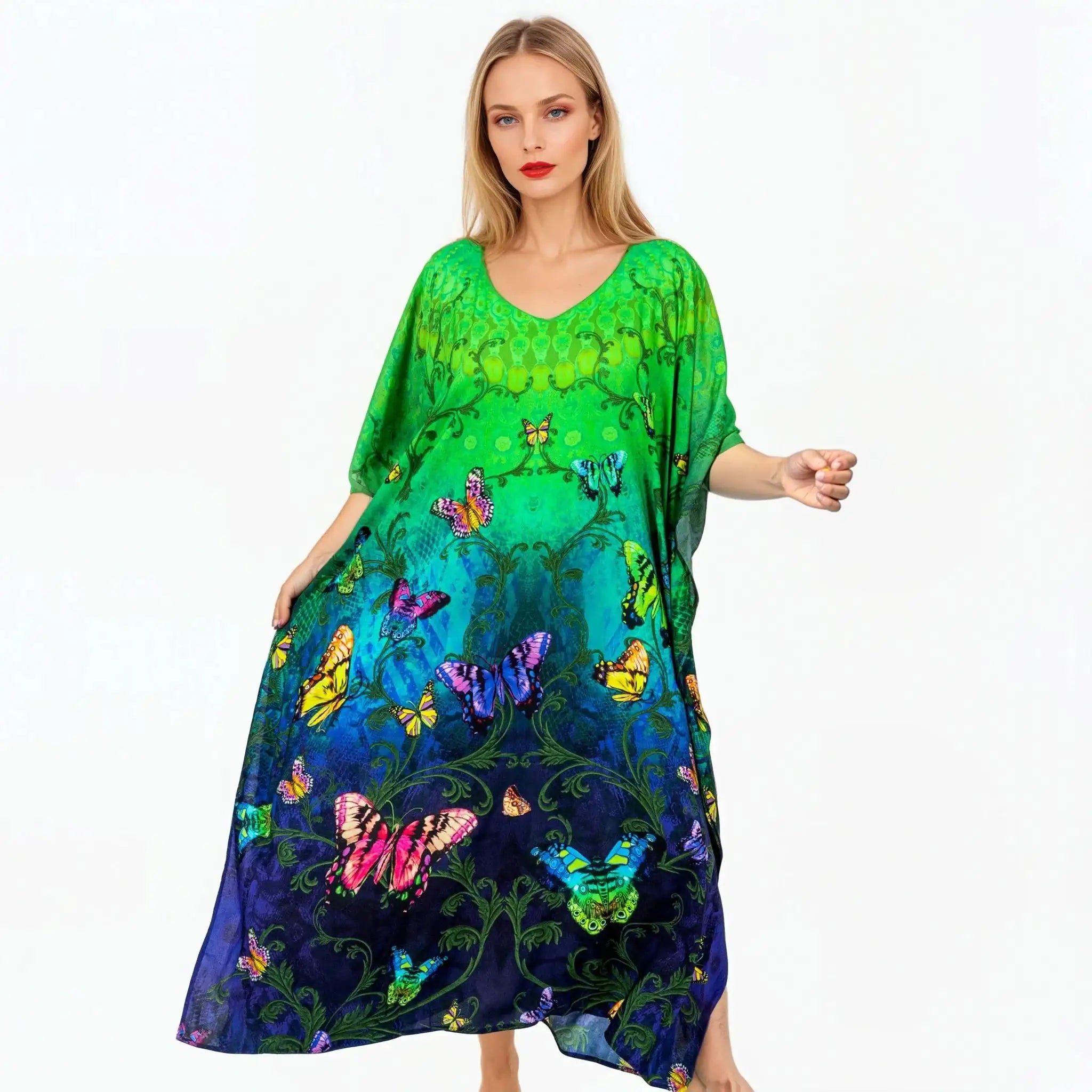 Woman wearing a vibrant green and blue butterfly print kaftan dress from Claire Powell