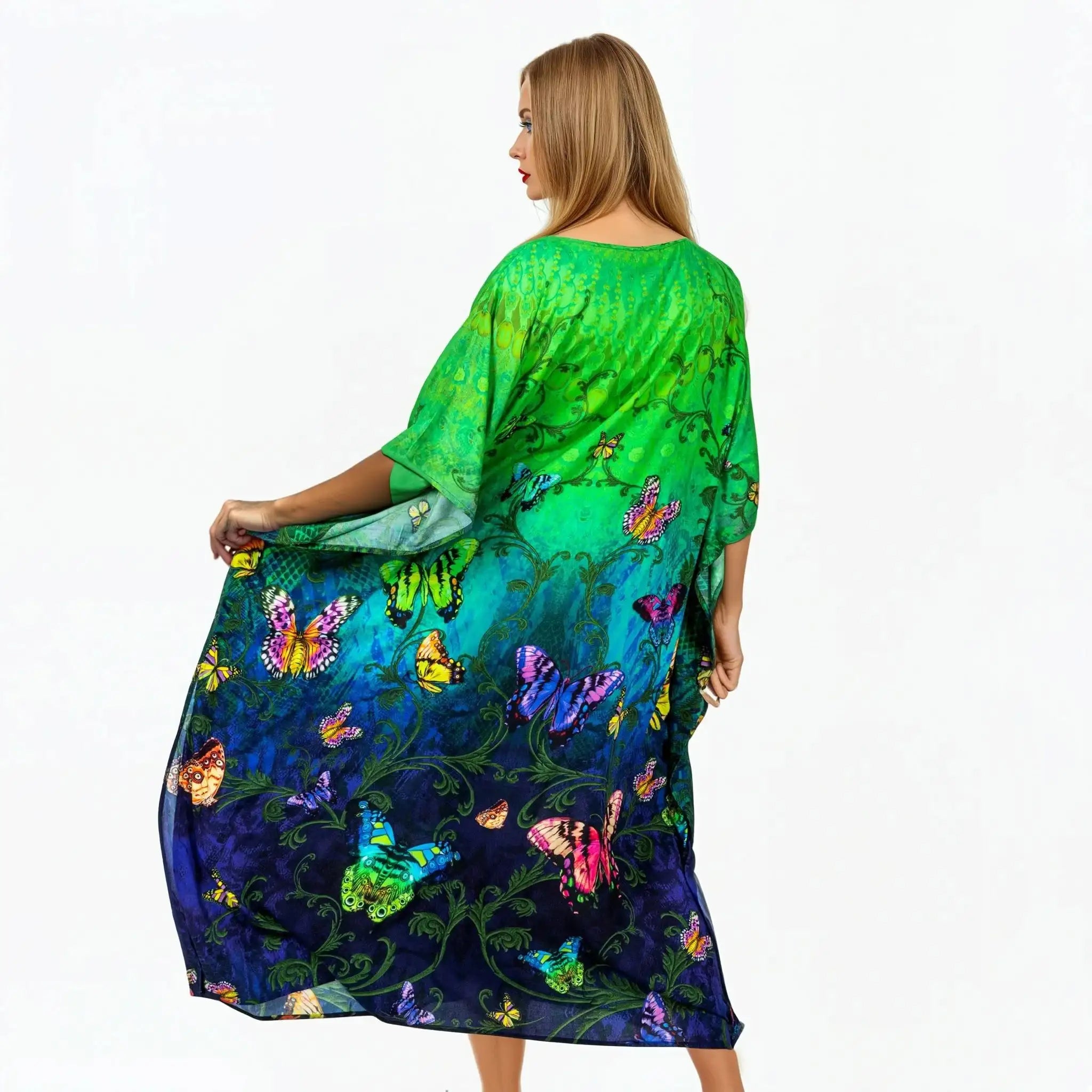 Woman modeling green and blue butterfly print kaftan dress by Claire Powell