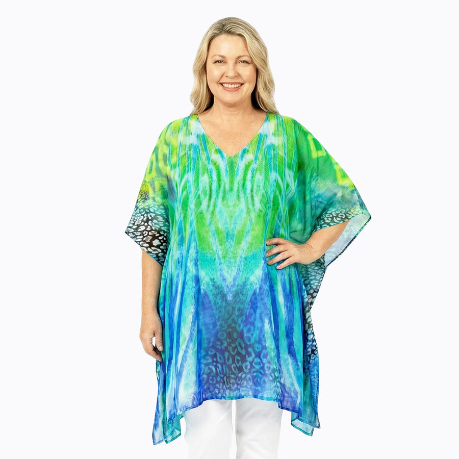 Woman wearing Claire Powell Plus Size Kaftan Top in Eden print, blue, teal and green, front view