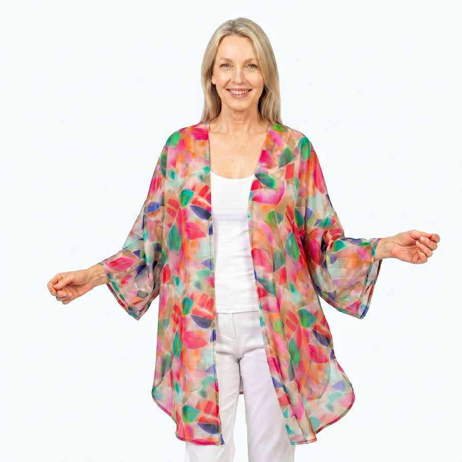 Woman wearing Claire Powell Cotton Chiffon Kimono Cover-Up in La Peach print, peach, apricot and coral, front view
