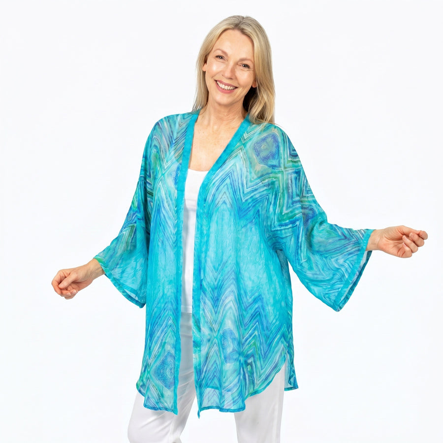 Woman wearing Claire Powell Cotton Chiffon Kimono Cover-Up in Serenity print, soft blue, aqua and white, front view