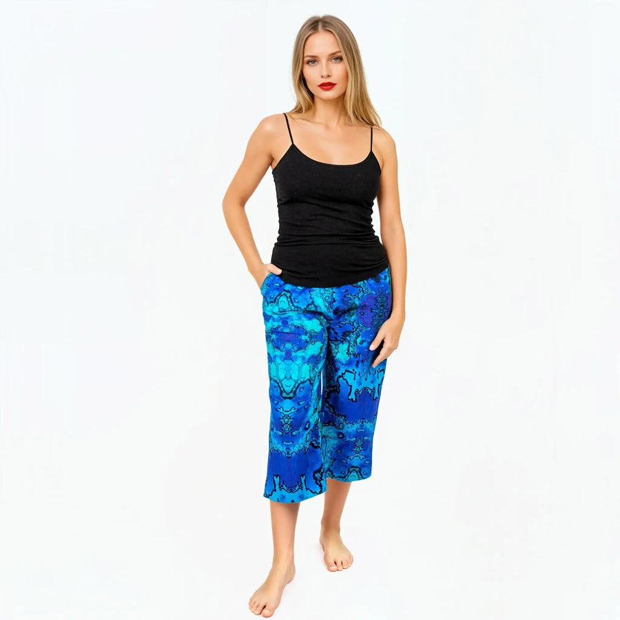 Woman wearing blue patterned culotte pants and black tank top from Claire Powell