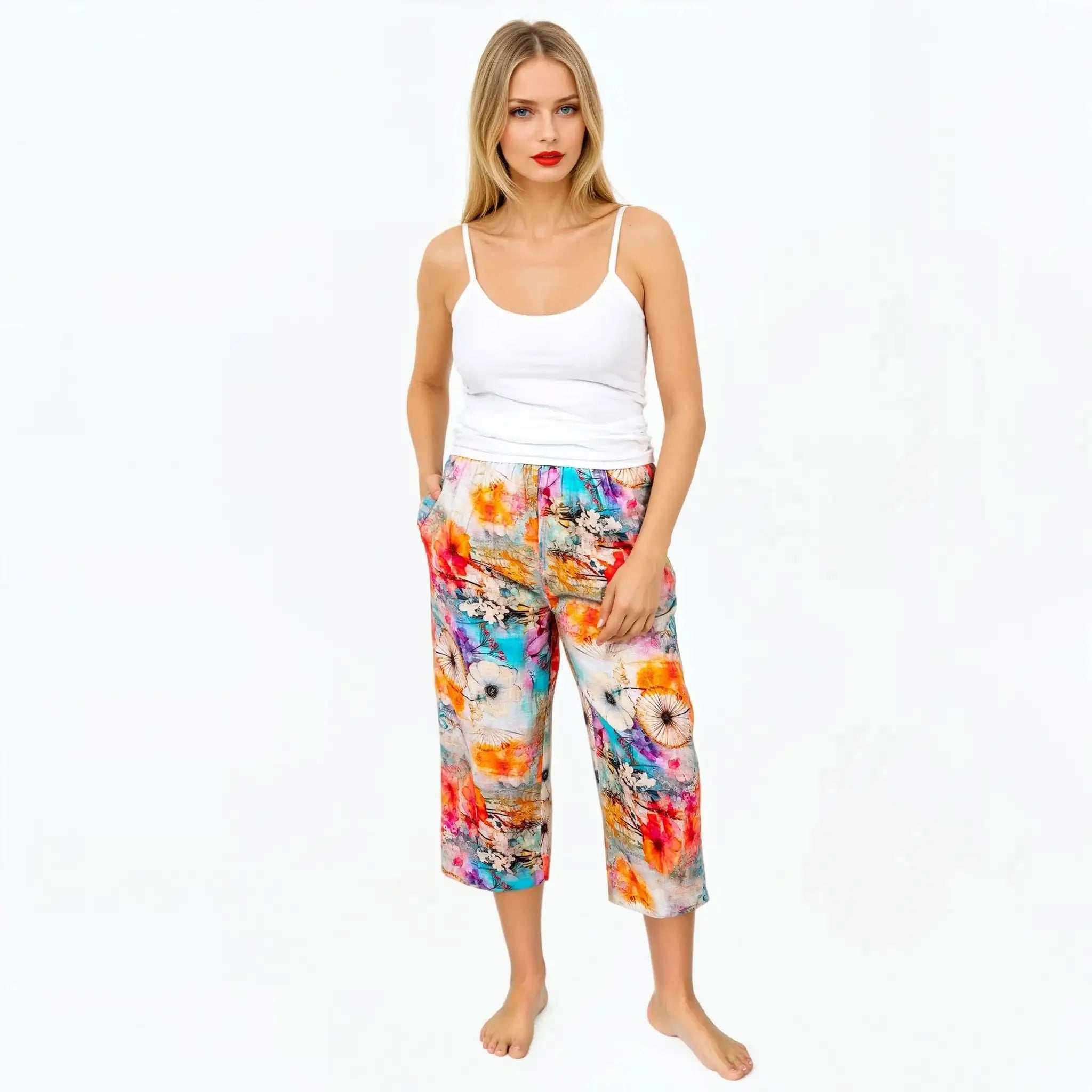 Woman in white tank top and colorful floral print pants, Claire Powell eco-friendly fashion
