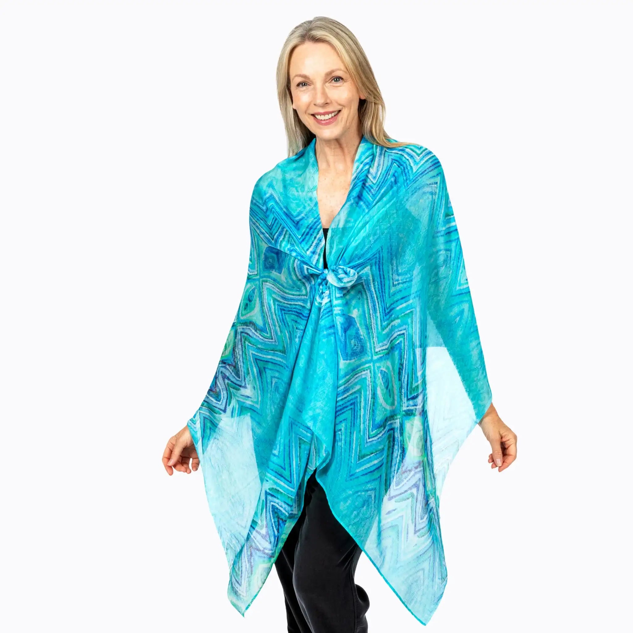 Woman wearing a turquoise patterned scarf from Claire Powell, eco-friendly women’s clothing