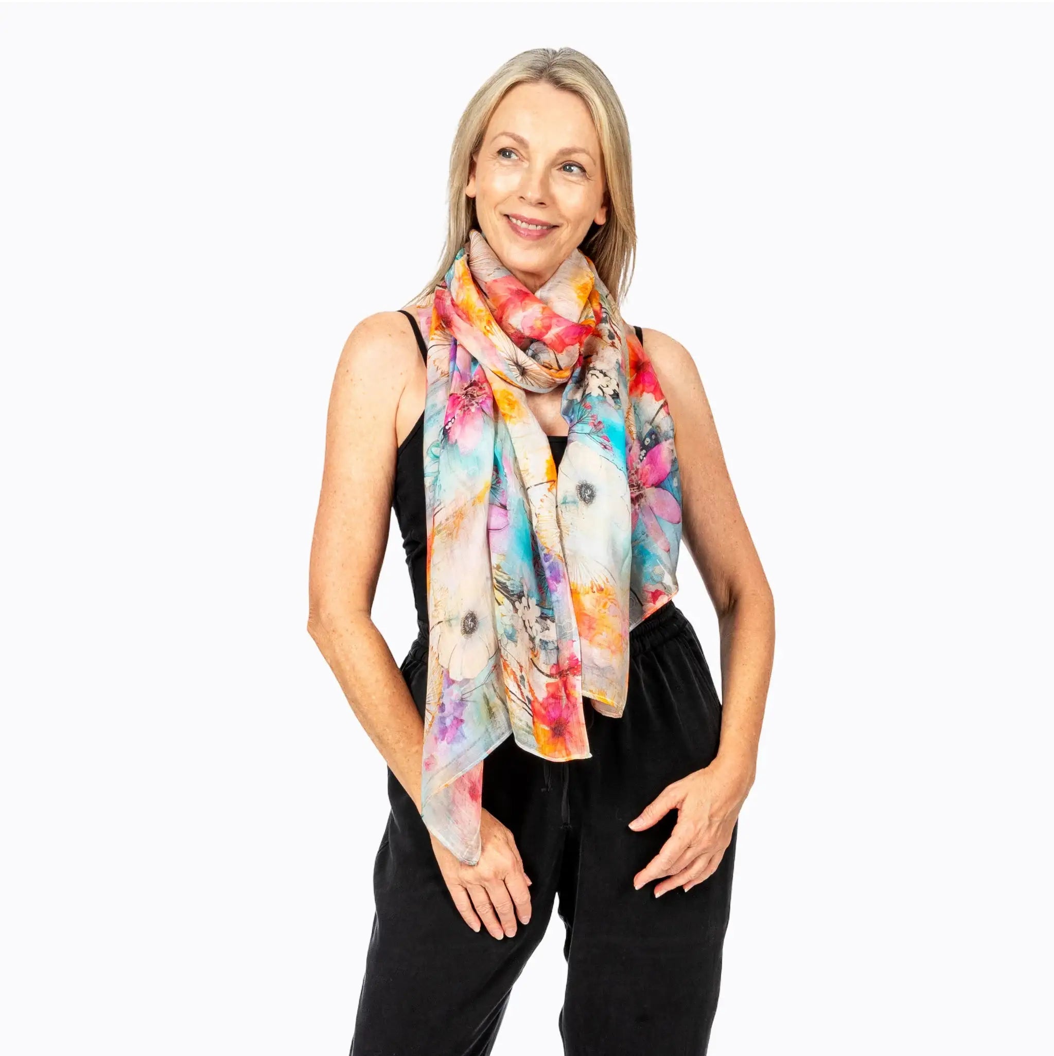 Woman wearing colorful floral scarf and black sleeveless jumpsuit, Claire Powell fashion