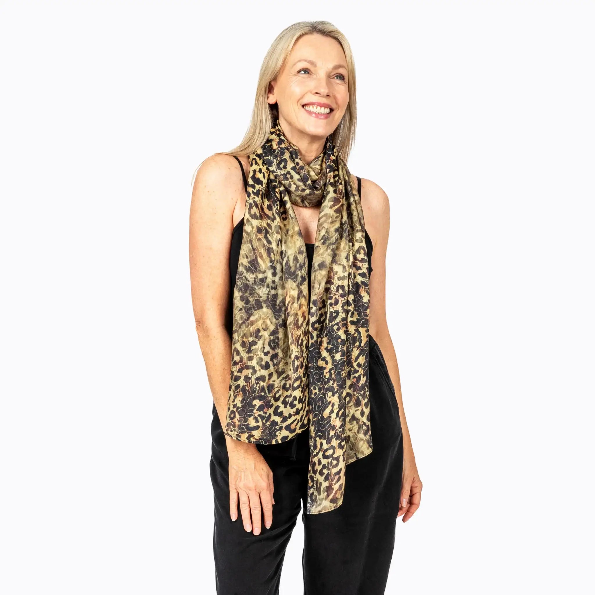 Woman wearing Claire Powell leopard print scarf and black sleeveless jumpsuit