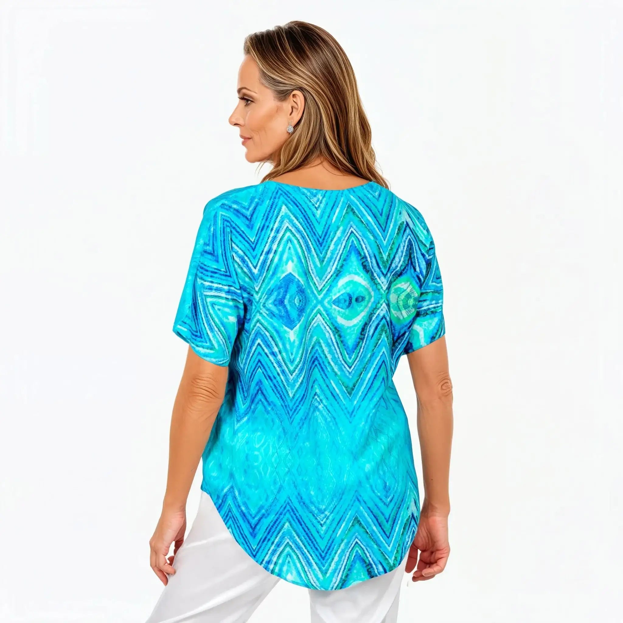 Woman wearing a blue patterned Claire Powell top, viewed from the back, stylish and eco-friendly clothing