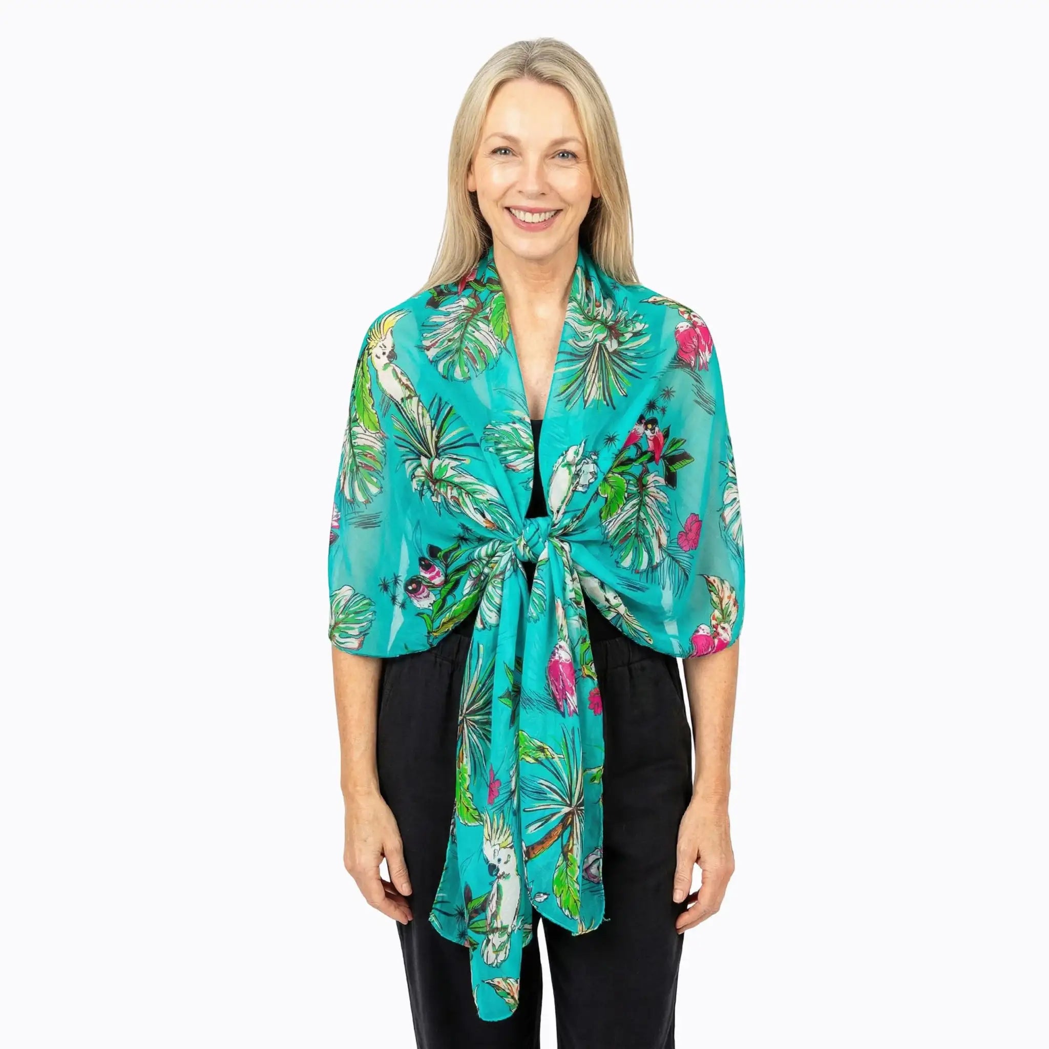 Woman wearing a turquoise silk scarf with tropical print, Claire Powell eco-friendly fashion