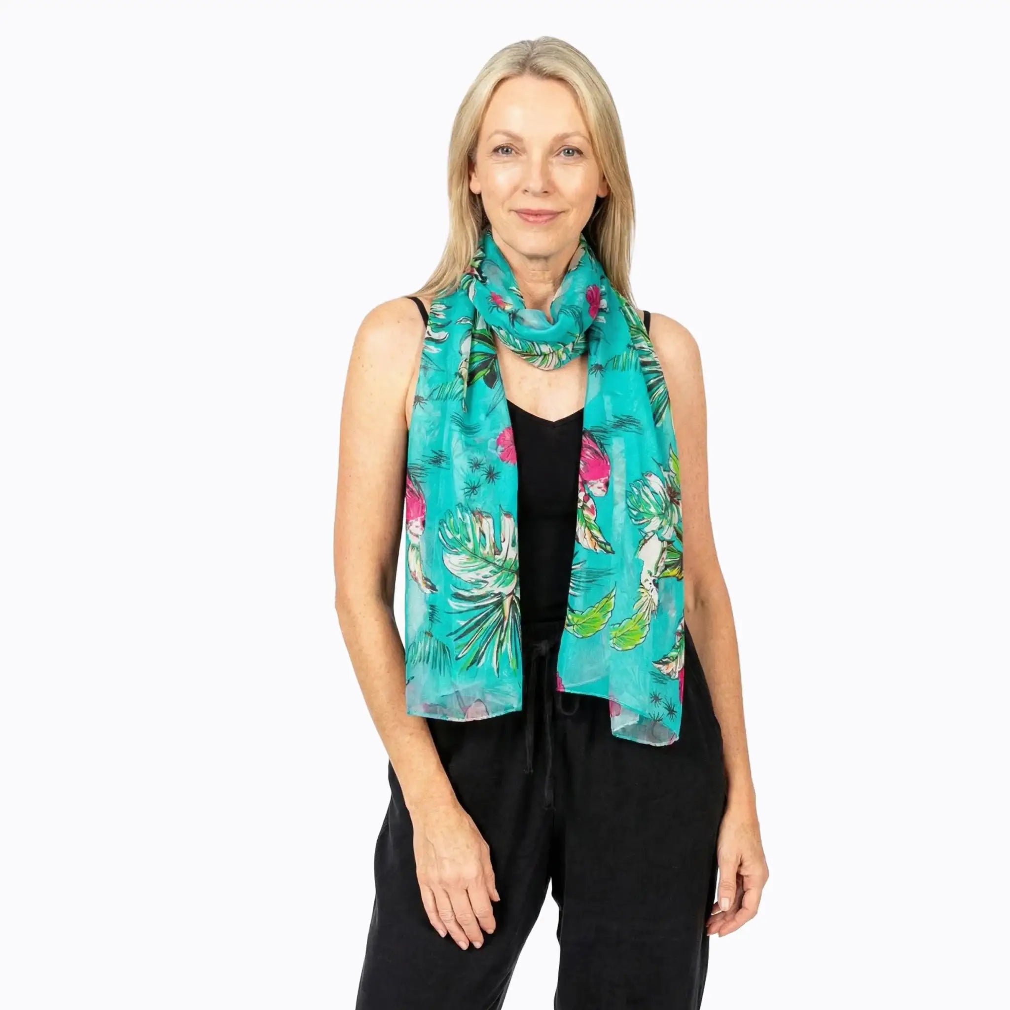 Woman wearing a turquoise silk floral scarf from Claire Powell eco-friendly fashion collection