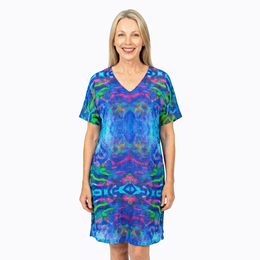 Woman wearing Claire Powell Shift Dress in Mirage print, blue, violet and teal, front view