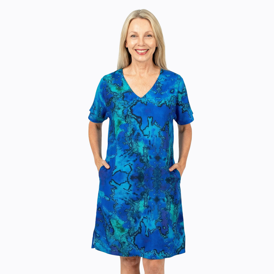Woman wearing Claire Powell Shift Dress in Reef print, blue and teal watercolour, front view
