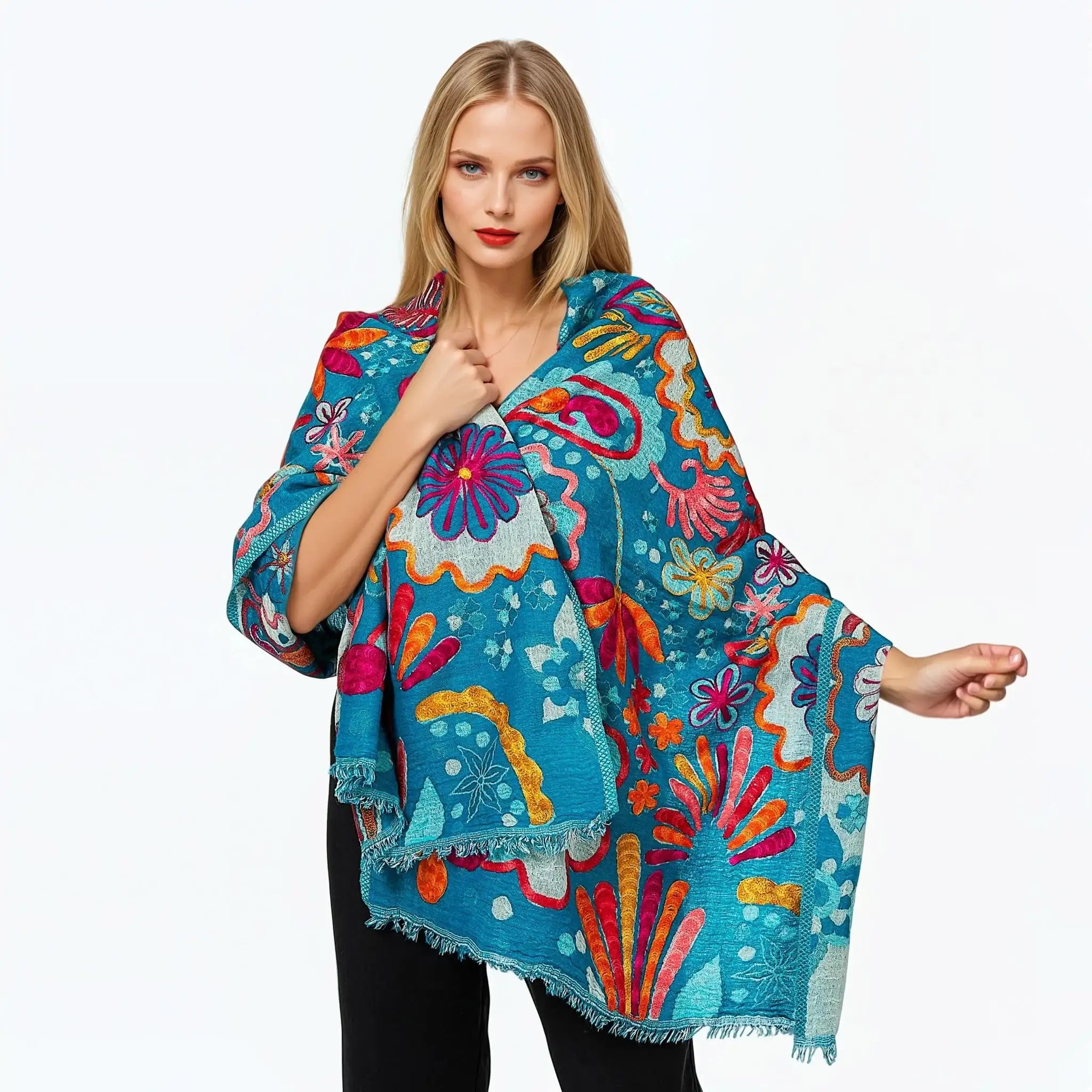 Woman wearing a vibrant turquoise floral kimono from Claire Powell collection