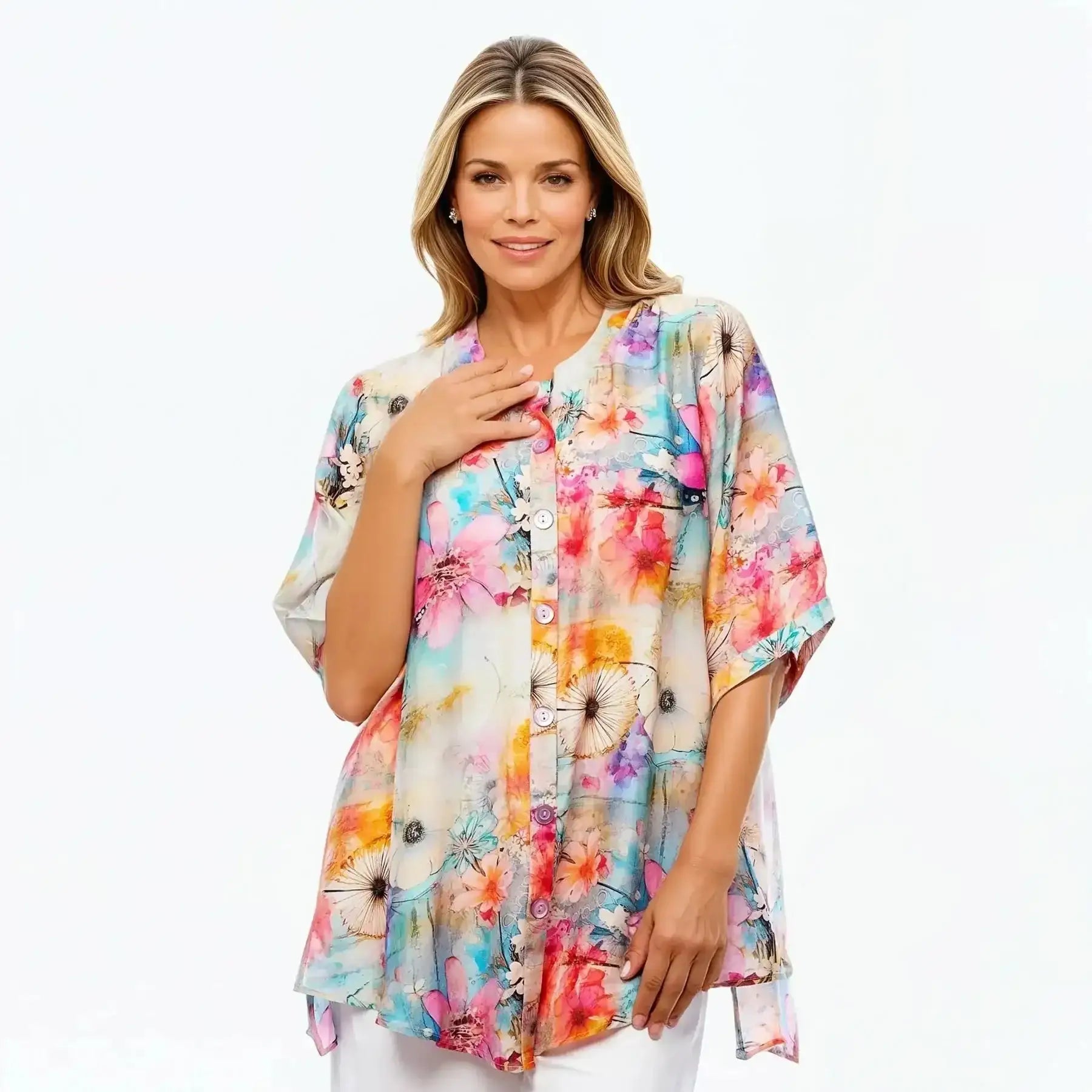 Woman wearing a colorful floral A-line button-front tunic blouse by Claire Powell.