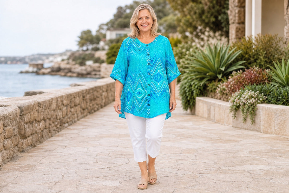 Approved Model B wearing the Claire Powell Serenity A-line tunic with white cotton-lycra capri pants by the coast