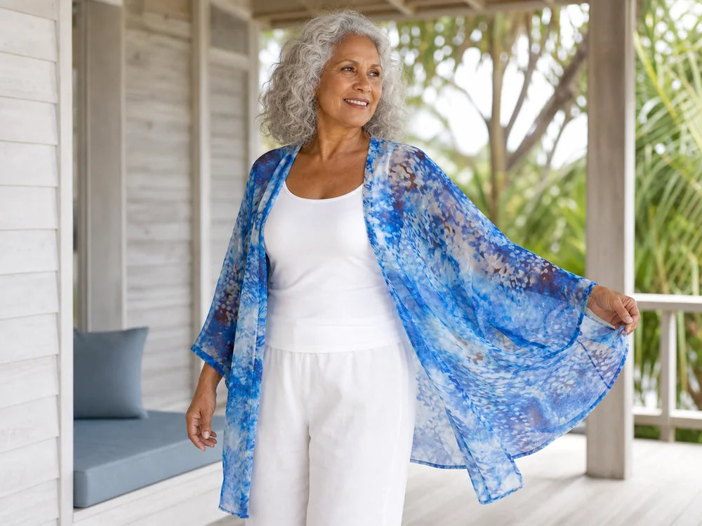 Woman wearing a Claire Powell Snowcat kimono cover-up