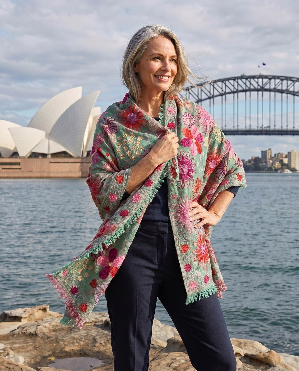 Woman wearing a black floral embroidered kimono from Claire Powell women's clothing collection