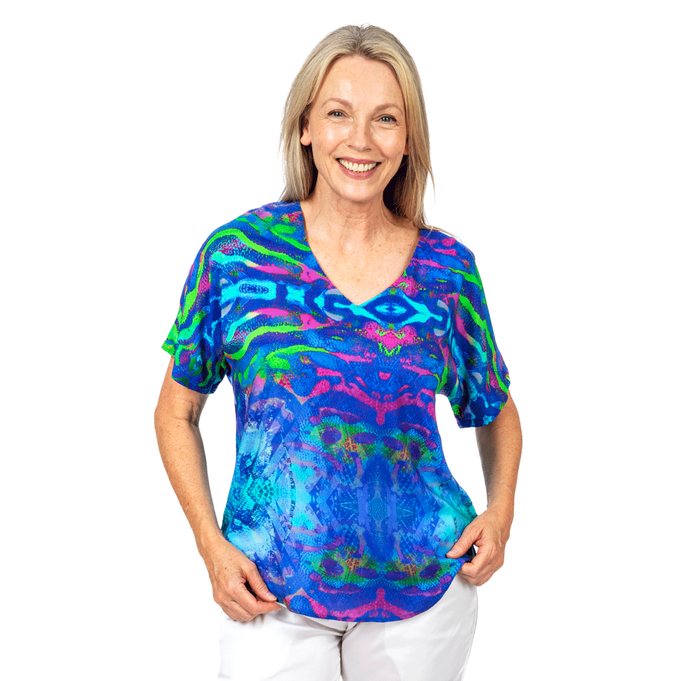 Woman wearing Claire Powell eco-friendly floral print top and white pants, stylish women's clothing