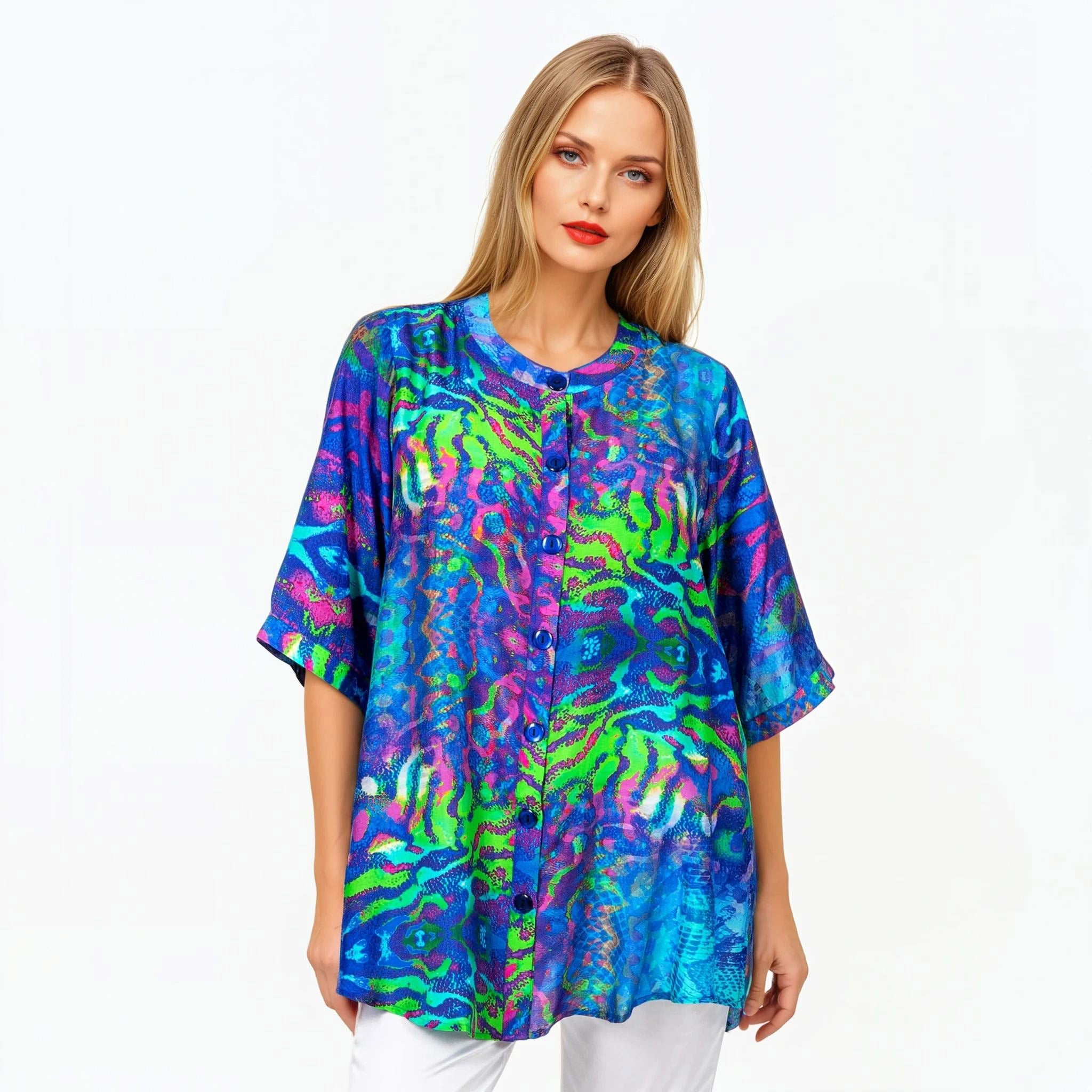 Woman wearing a colorful floral button-up top by Claire Powell, eco-friendly women's fashion